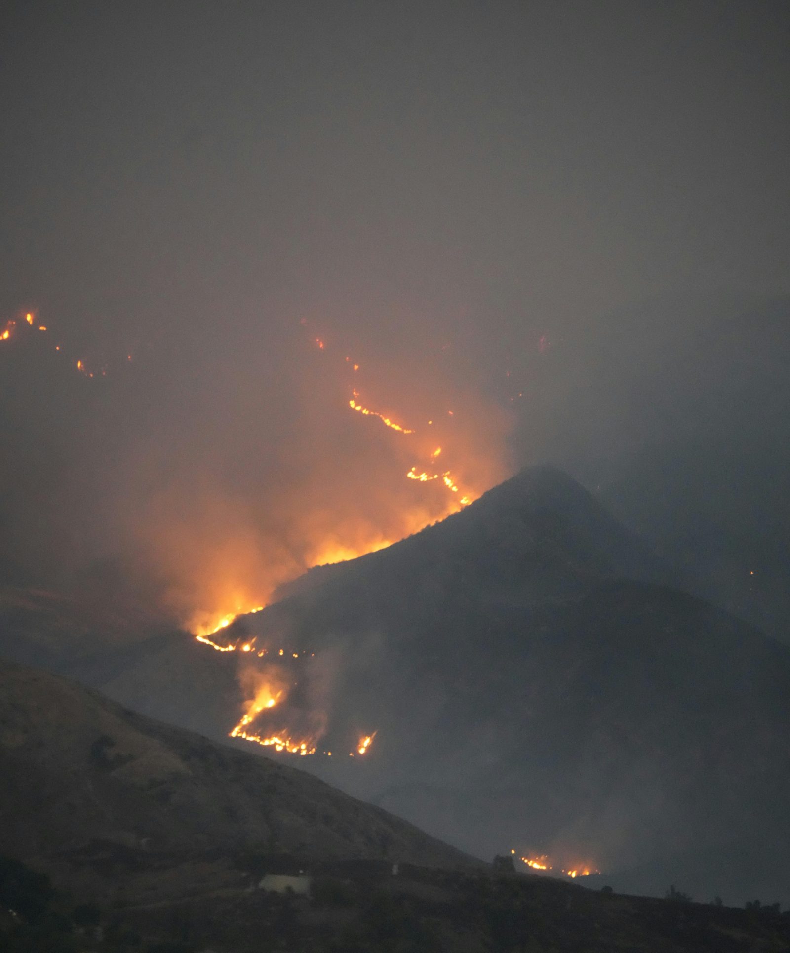 Wildfire on hillside at night
